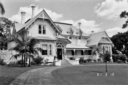 The exterior of Tighnabruaich, a two storey wooden villa.