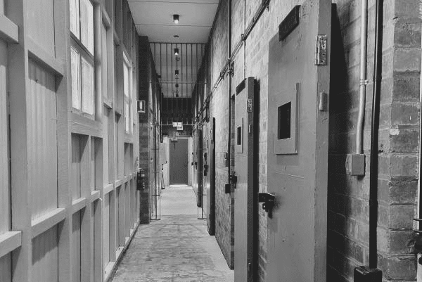 A black and white photo of the corridor in the cell blocks